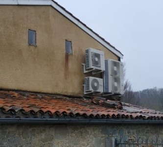 installation pompe a chaleur climatisation sur la façade d'une maison en hauteur